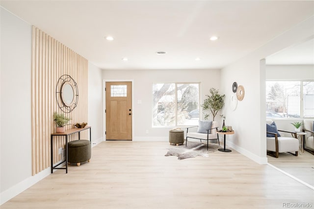 entrance foyer with baseboards, wood finished floors, and recessed lighting