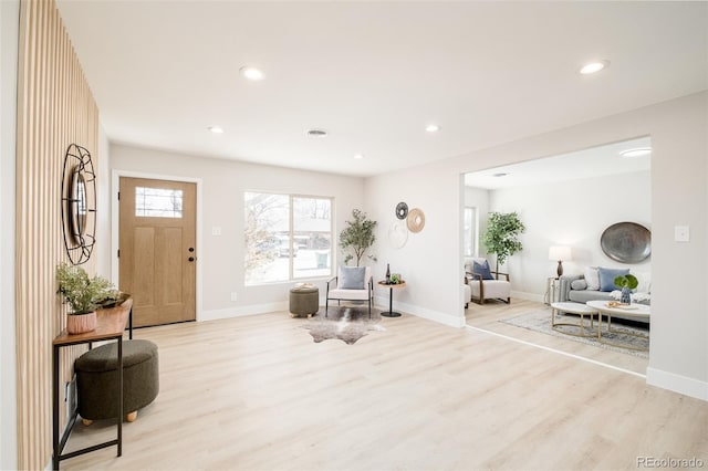 entryway with baseboards, wood finished floors, and recessed lighting