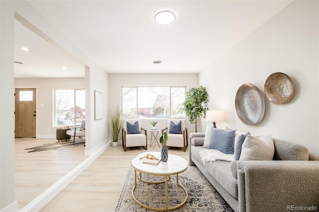 living area featuring baseboards, recessed lighting, visible vents, and light wood-style floors