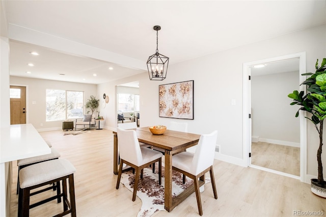 dining area featuring baseboards, light wood-style flooring, and recessed lighting