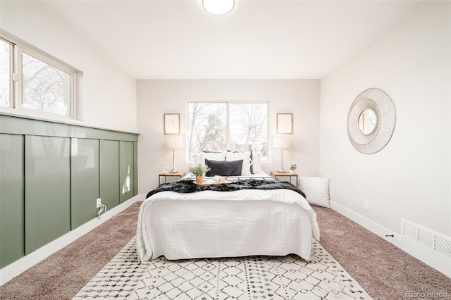 bedroom with carpet, visible vents, and baseboards