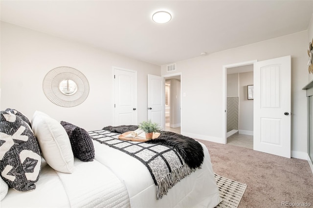 bedroom featuring light carpet, baseboards, visible vents, and a closet