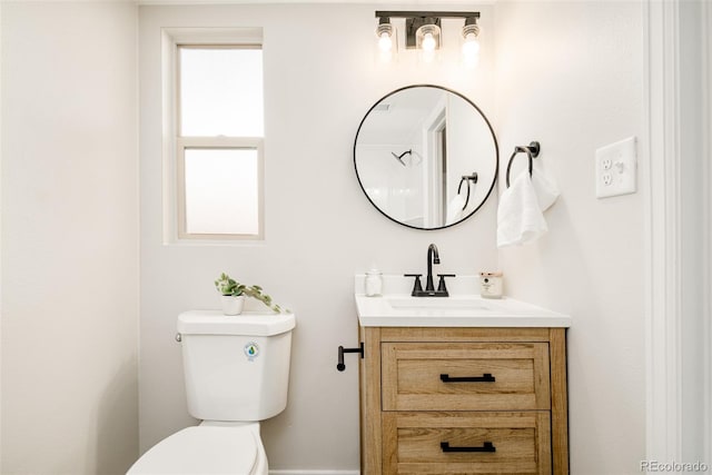 bathroom featuring toilet and vanity