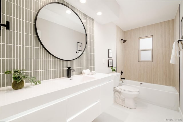 full bath featuring  shower combination, tile walls, toilet, and vanity