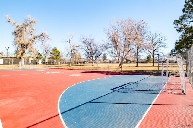 view of sport court featuring fence