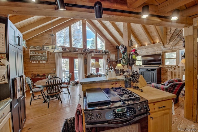 kitchen with light hardwood / wood-style flooring, beamed ceiling, wood walls, black range, and wood ceiling