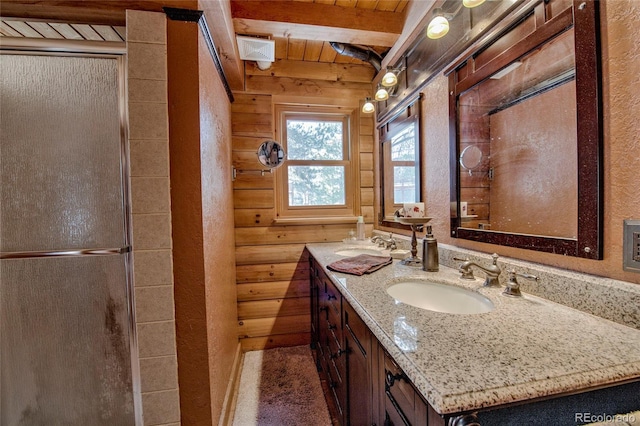 bathroom featuring vanity, wooden ceiling, wooden walls, beam ceiling, and a shower with shower door