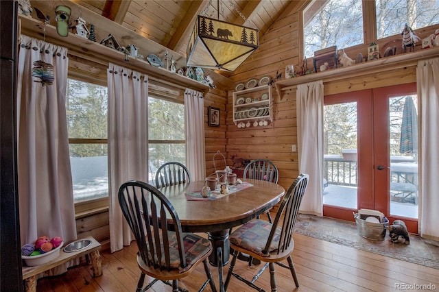 dining area with plenty of natural light, wood-type flooring, and wooden ceiling