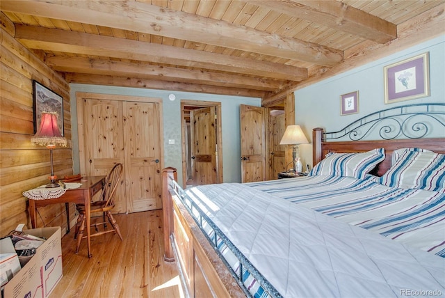 bedroom featuring beam ceiling, light wood-type flooring, wooden walls, and wood ceiling