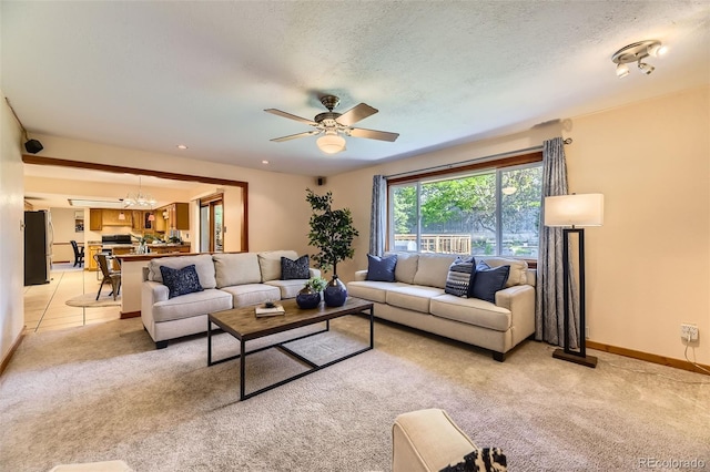 6708 W Portland Ave, Littleton, CO 80128 - living area featuring light colored carpet, a ceiling fan, a chandelier, baseboards, and a textured ceiling