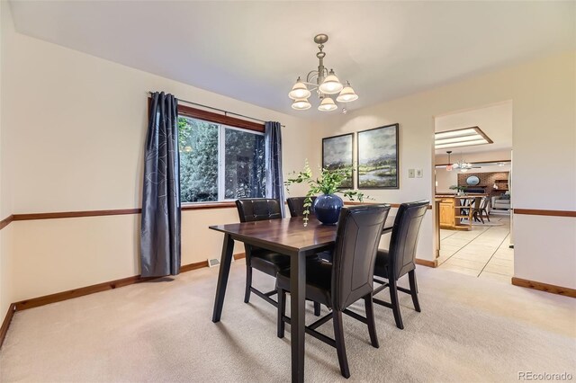 6708 W Portland Ave, Littleton, CO 80128 - dining room with a chandelier, light carpet, and baseboards
