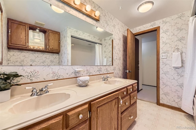 6708 W Portland Ave, Littleton, CO 80128 - bathroom featuring tile patterned floors, double vanity, and wallpapered walls