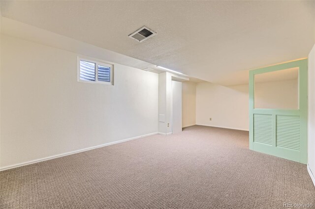 6708 W Portland Ave, Littleton, CO 80128 - below grade area featuring carpet, baseboards, and a textured ceiling