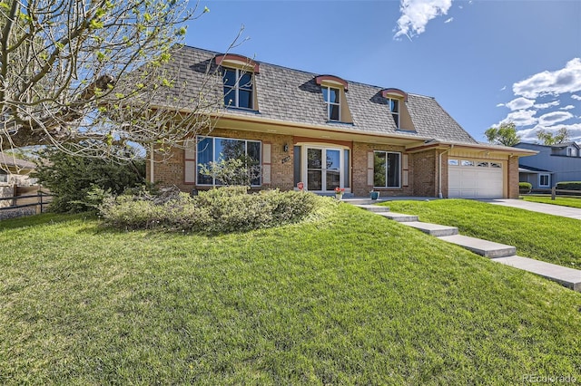 6708 W Portland Ave, Littleton, CO 80128 - view of front of house with mansard roof, brick siding, an attached garage, driveway, and a shingled roof