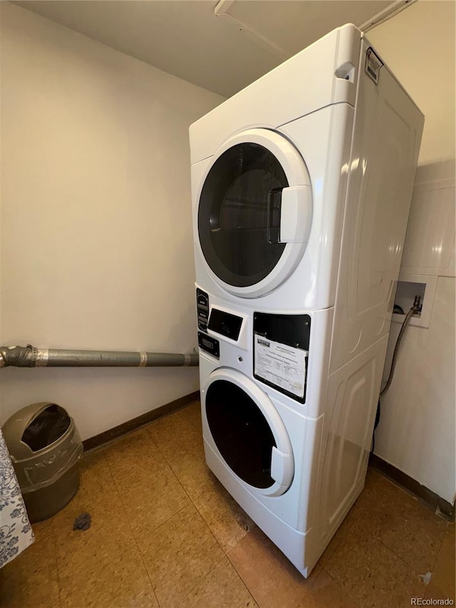 31270 John Wallace Rd Unit 306, Evergreen, CO 80439 - laundry room with stacked washing machine and dryer and baseboards