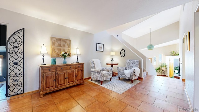 sitting room featuring lofted ceiling and light tile patterned floors