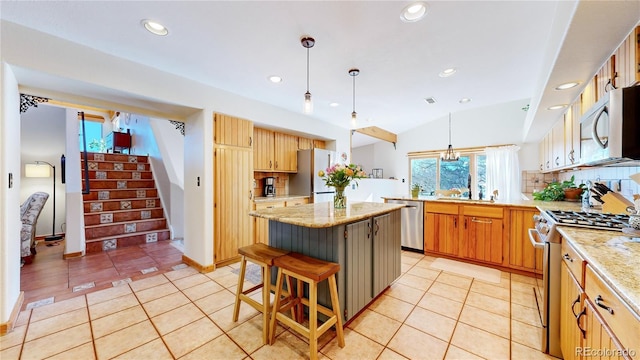 kitchen featuring light tile patterned floors, appliances with stainless steel finishes, backsplash, decorative light fixtures, and a center island