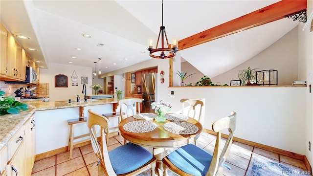 tiled dining area featuring lofted ceiling and a chandelier