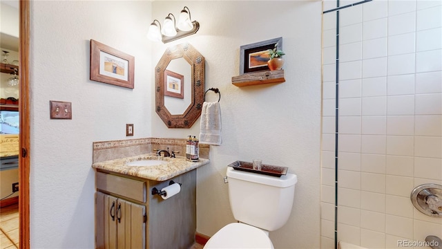 bathroom featuring toilet and vanity