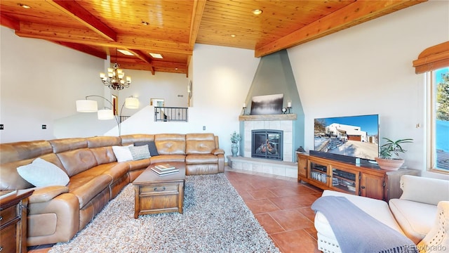 tiled living room featuring a notable chandelier, wooden ceiling, a tiled fireplace, and beamed ceiling