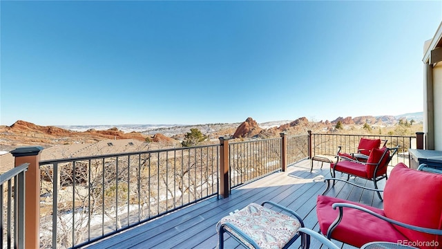 wooden deck with a mountain view