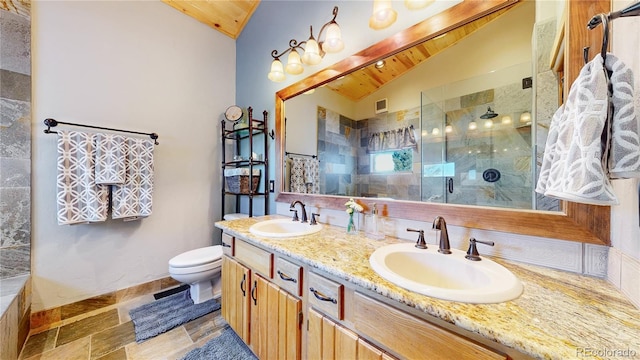 bathroom featuring toilet, vanity, vaulted ceiling, and a shower with door