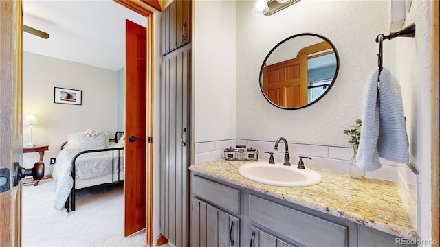 bathroom with vanity and decorative backsplash