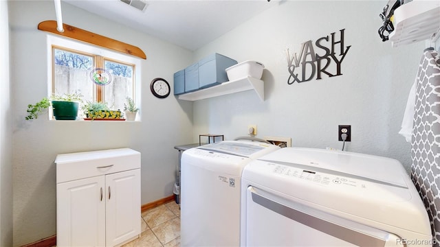 laundry area featuring cabinets, light tile patterned floors, and separate washer and dryer