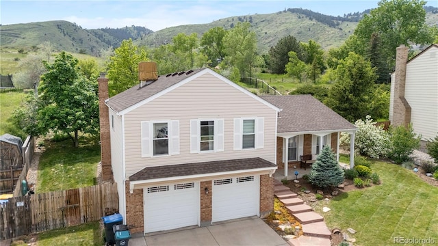 229 Berthoud Way, Golden, CO 80401 - traditional home featuring a mountain view, a shingled roof, brick siding, and a chimney