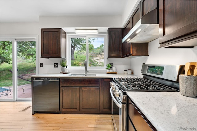 229 Berthoud Way, Golden, CO 80401 - kitchen with dishwasher, stainless steel gas stove, extractor fan, dark brown cabinetry, and light wood-style floors