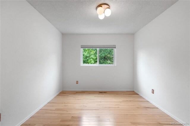 229 Berthoud Way, Golden, CO 80401 - empty room with light wood finished floors and a textured ceiling