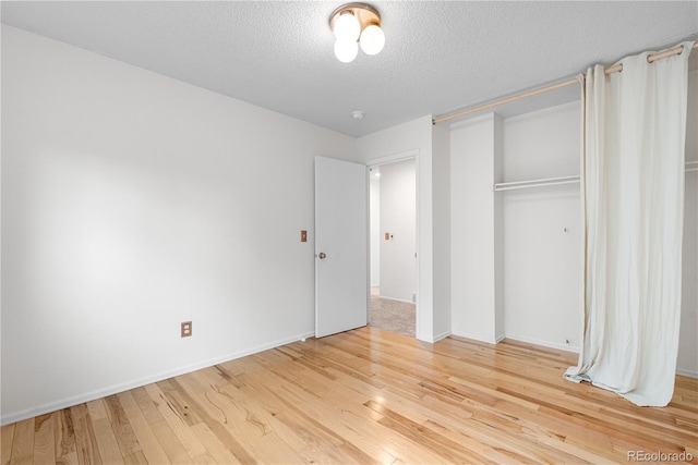 229 Berthoud Way, Golden, CO 80401 - unfurnished bedroom with hardwood / wood-style flooring, a textured ceiling, and a closet