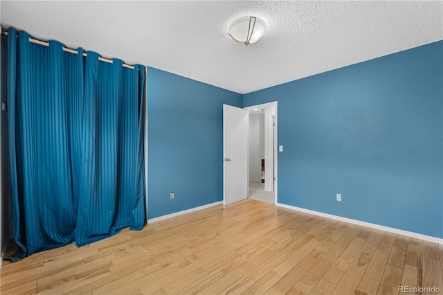 229 Berthoud Way, Golden, CO 80401 - empty room with wood finished floors and a textured ceiling