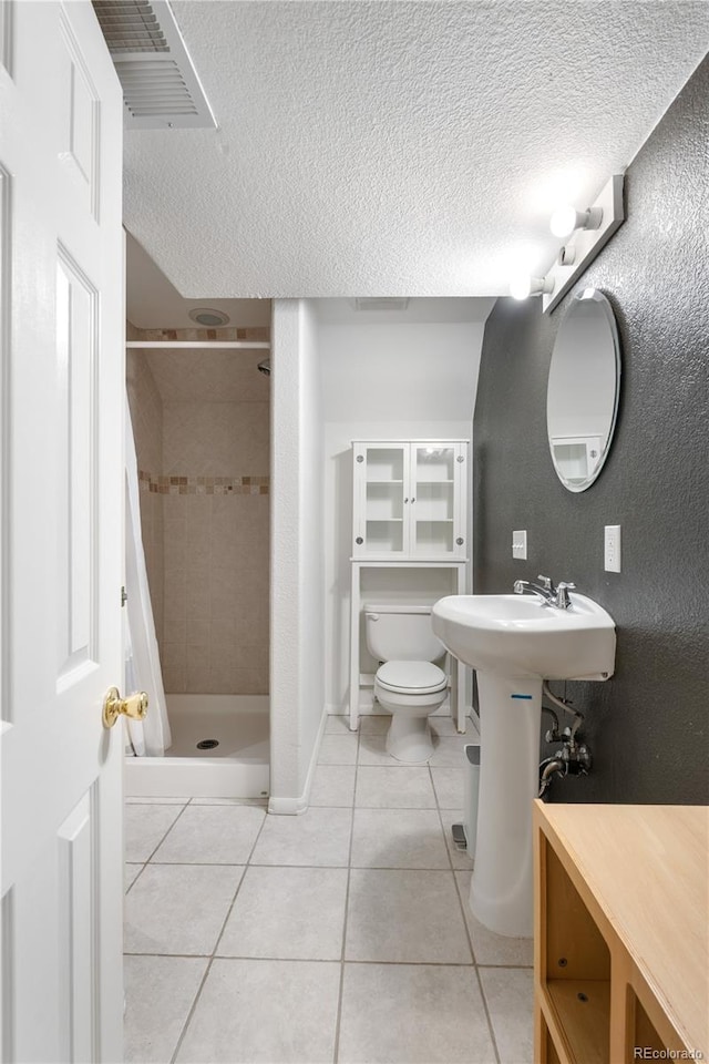 229 Berthoud Way, Golden, CO 80401 - bathroom featuring tile patterned flooring, a stall shower, and a textured ceiling