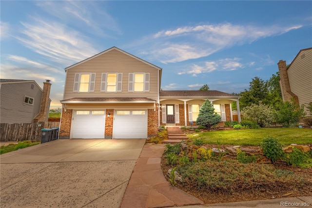 229 Berthoud Way, Golden, CO 80401 - view of front of property with an attached garage, concrete driveway, brick siding, and a porch