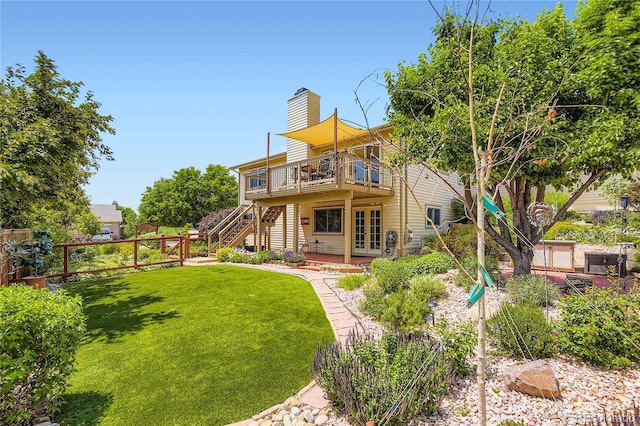 702 Windmill Pl, Highlands Ranch, CO 80126 - back of house featuring a chimney, a wooden deck, stairs, and french doors