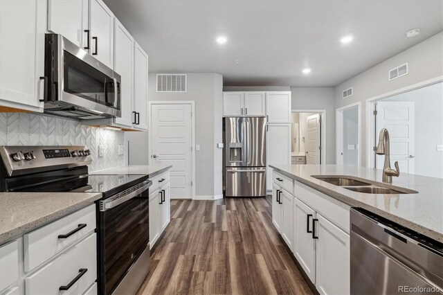 kitchen featuring appliances with stainless steel finishes, a sink, and visible vents