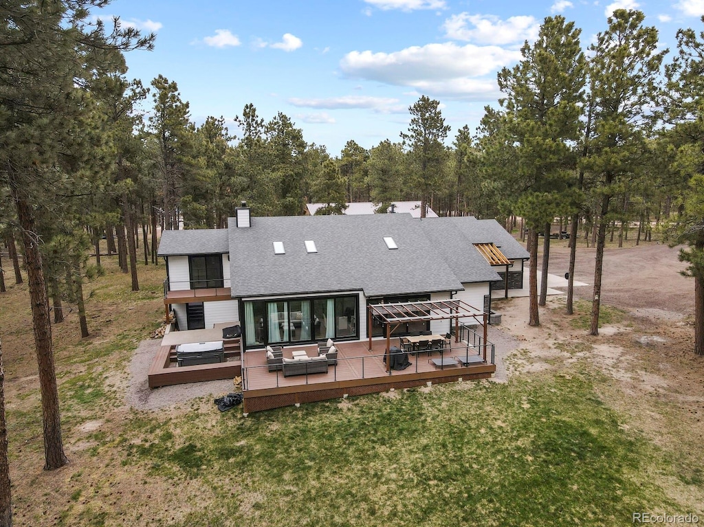 back of house featuring an outdoor living space and a deck