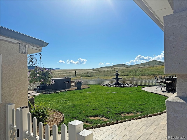 view of yard featuring a mountain view and a patio