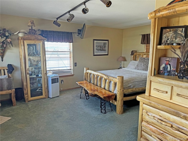 carpeted bedroom featuring track lighting