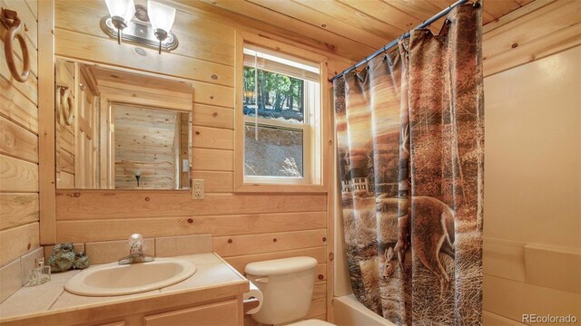 155 Squilchuck Trl, Woodland Park, CO 80863 - bathroom with toilet, wood walls, shower / bath combo, and vanity