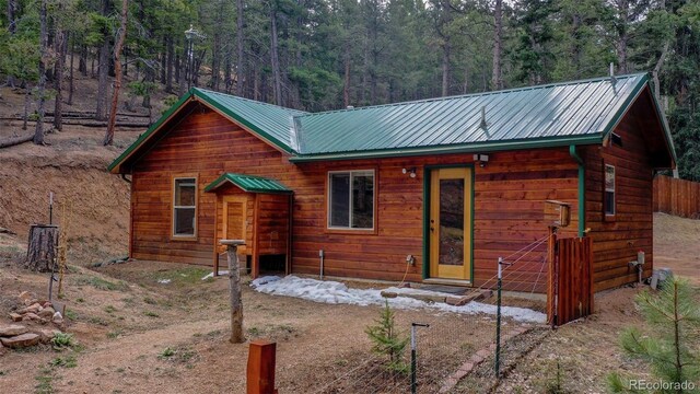 155 Squilchuck Trl, Woodland Park, CO 80863 - exterior space featuring entry steps, a view of trees, and metal roof