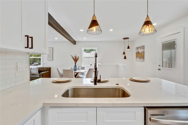 2701 Barnhart St, Thornton, CO 80229 - kitchen featuring stainless steel dishwasher, a sink, plenty of natural light, hanging light fixtures, and recessed lighting
