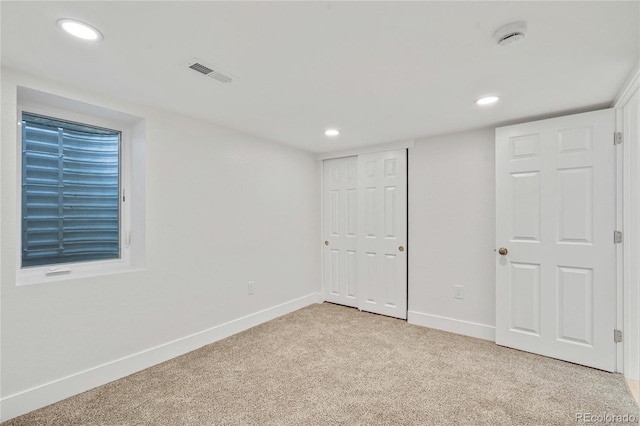2701 Barnhart St, Thornton, CO 80229 - unfurnished bedroom featuring light carpet, baseboards, recessed lighting, and a closet