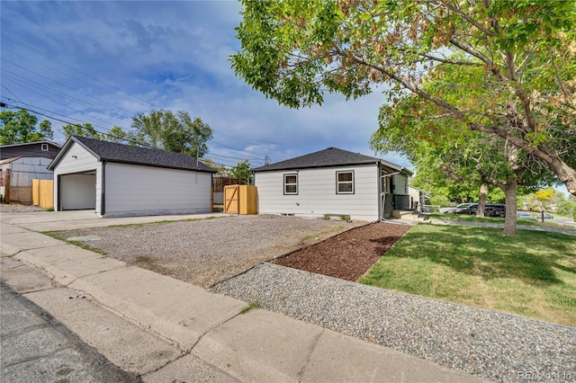 2701 Barnhart St, Thornton, CO 80229 - view of front of house featuring driveway, an outdoor structure, and a detached garage
