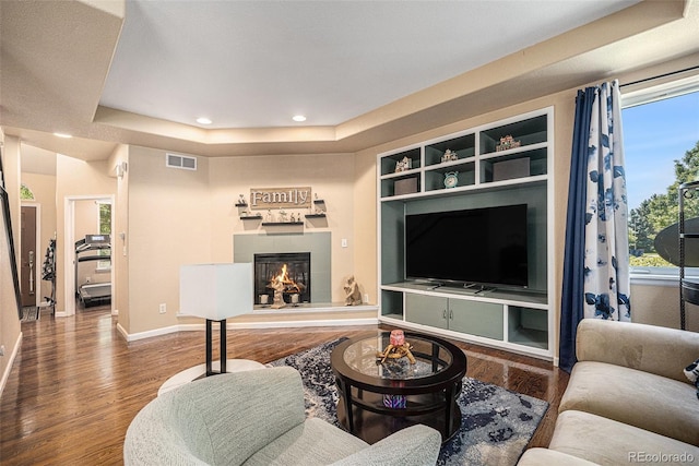 12051 E Lake Cir, Greenwood Village, CO 80111 - living area featuring healthy amount of natural light, wood finished floors, a tiled fireplace, and recessed lighting