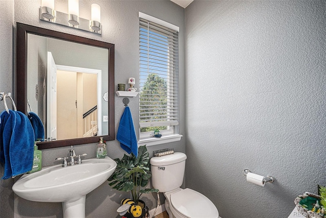 12051 E Lake Cir, Greenwood Village, CO 80111 - half bathroom featuring a sink and a textured wall