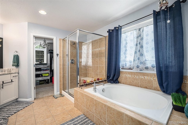 12051 E Lake Cir, Greenwood Village, CO 80111 - full bathroom featuring a stall shower, a garden tub, vanity, healthy amount of natural light, and recessed lighting