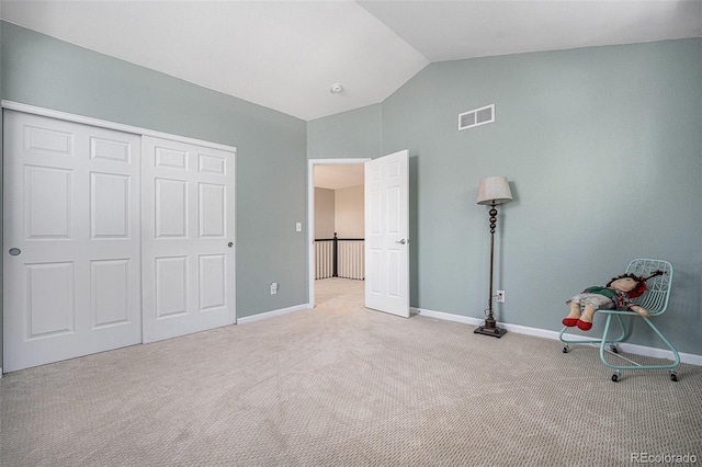12051 E Lake Cir, Greenwood Village, CO 80111 - unfurnished bedroom with vaulted ceiling, carpet floors, and a closet