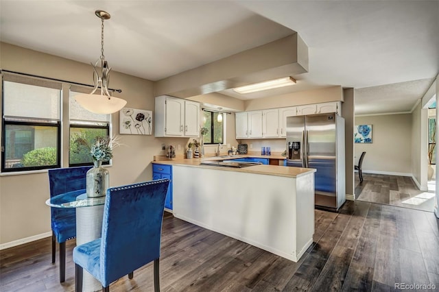 kitchen with a healthy amount of sunlight, decorative light fixtures, dark hardwood / wood-style floors, stainless steel refrigerator with ice dispenser, and white cabinets